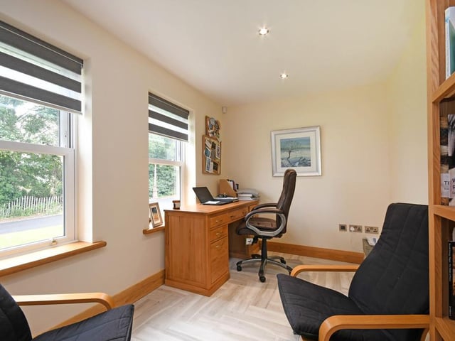 The study off the hallway looks out onto the private road.
