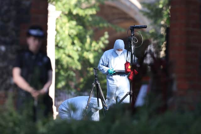 Police forensics officers near Forbury Gardens, in Reading town centre, the scene of a multiple stabbing attack which took place at around 7pm on Saturday, leaving three people dead and another three seriously injured. Steve Parsons/PA Wire
