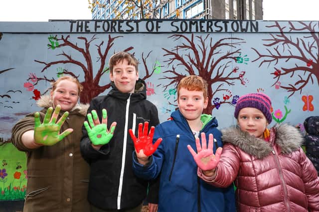 From left, Yazmin, Bohdi, Aiden and Luna Charley show their paint-covered hands after adding their prints to the mural.
Picture: Stuart Martin (220421-7042)