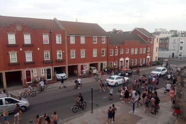 Youths at the Hotwalls in Old Portsmouth on July 25 after police are seen making arrests. Picture: Neil Fatkin
