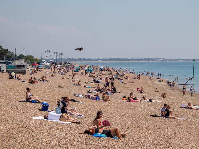 Pictured: People enjoying the sunshine on the beach