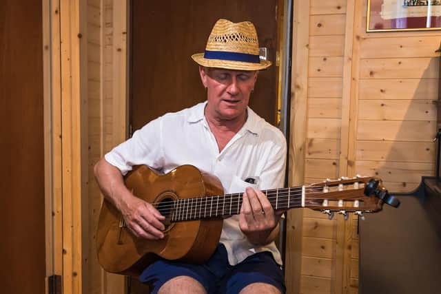 Hayling Island musician Mark Handley (64) strumming in one of the session rooms at Therapy Room recording studio. Picture: Mike Cooter (190721)