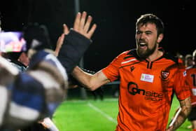 Portchester's Ryan Wilkins celebrate his side's dramatic win at Hythe with supporters last night. Picture by Nathan Lipsham