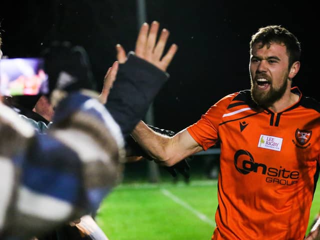 Portchester's Ryan Wilkins celebrate his side's dramatic win at Hythe with supporters last night. Picture by Nathan Lipsham