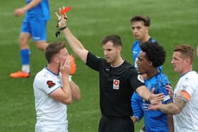 Jake McCarthy is shown a red card by Harry Wager. Picture by Dave Haines