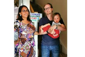 Simon Hoyle from Denvilles took on the equivalent of the Three Peaks challenge on his stairs at home to raise money for Portsmouth Down Syndrome which has helped the family since his son Dexter was born with the condition. Pictured: Simon with his wife Anjali and son Dexter