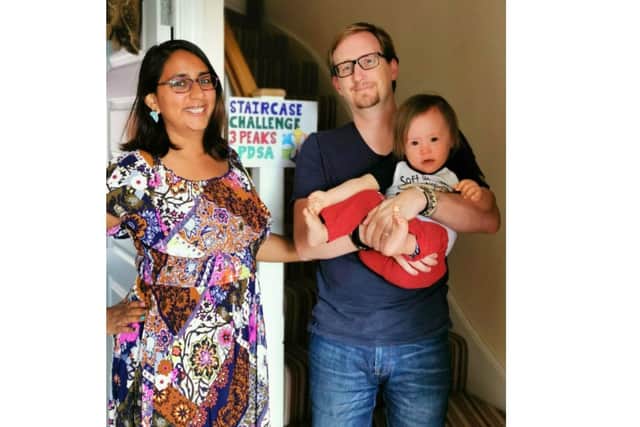 Simon Hoyle from Denvilles took on the equivalent of the Three Peaks challenge on his stairs at home to raise money for Portsmouth Down Syndrome which has helped the family since his son Dexter was born with the condition. Pictured: Simon with his wife Anjali and son Dexter