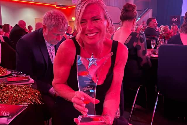 Not only a rising star but a shining star look at that smile proudly showing off her award
