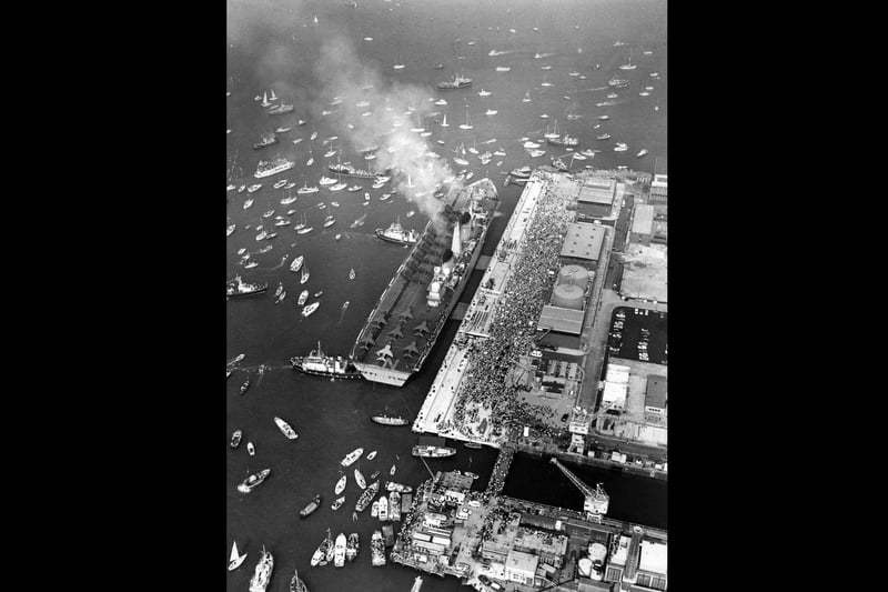 HMS Invicible is nudged into place by tugs as she returns to Portsmouth in September 1982 after the Falklands. The News PP695