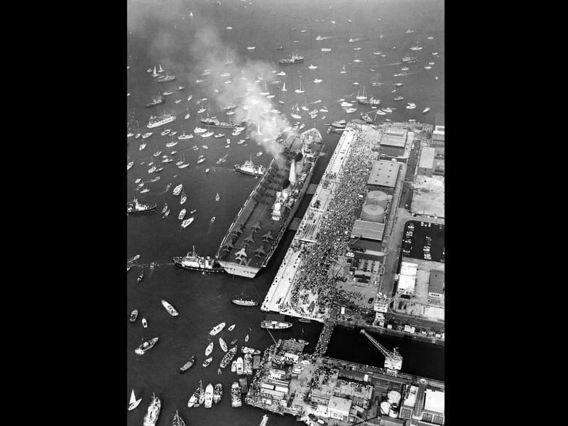 HMS Invicible is nudged into place by tugs as she returns to Portsmouth in September 1982 after the Falklands. The News PP695