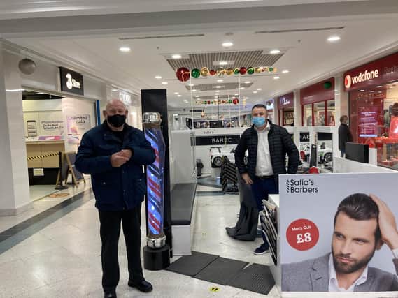 Aleks Vuksani, 43, from Southsea was ready to cur hair at Safias Barbers in Fareham Shopping Centre, with customer Colin White, 77, from Waterlooville.
