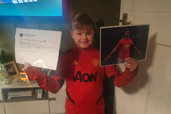 Jacob's Well volunteer Rogan Morrill had his hard work recognised by footballer Marcus Rashford. Pictured: An excited Rogan with a print out of the tweet and a picture of Rashford