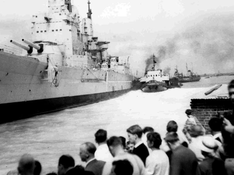 A different view of HMS Vanguard when she came adrift when being towed out of the harbour and ran into Point, Old Portsmouth.
Leaving the harbour at 10.00 on 4 August 1960 and at 10.35 she ran aground into 24ft of water. She was aground for 40 minutes before being towed out into the mainstream and on her way to the breakers yard at Faslane.