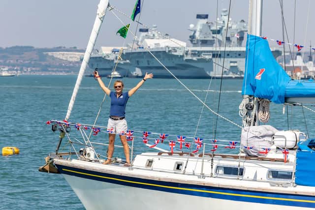 Sally Titmus (56) waves to family and friends at the entrance to Portsmouth Harbour after being away for four years. Picture: Mike Cooter (130822)
