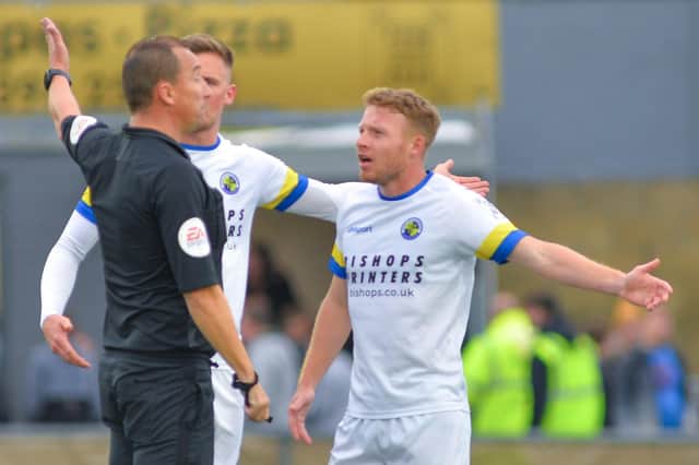 Tommy Wright talks to referee Dean Skipper during Hawks' National League South loss to Slough - Wright was later sent off. Picture: Martyn White