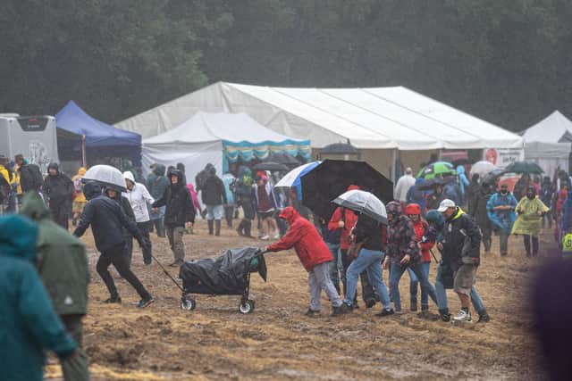 Fighting against the mud and hillside to get to the bar at Wickham Festival. Picture: Andy Hornby