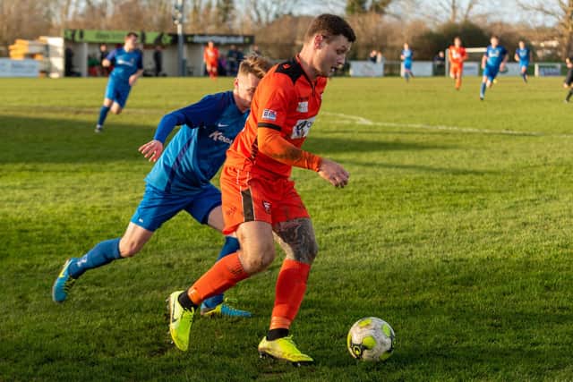 Joe Noakes (orange) in action for AFC Portchester against Baffins in February 2020. Picture: Vernon Nash