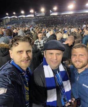 Family support: Chris, centre, at Fratton Park with his brothers Mathew and Ashley