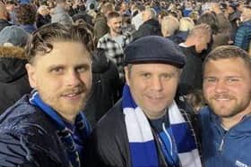 Family support: Chris, centre, at Fratton Park with his brothers Mathew and Ashley