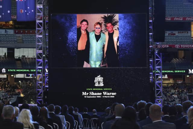 A photo of Elton John and Shane Warne is projected onto a screen during a memorial service for Warne at the Melbourne Cricket Ground in Melbourne. AP Photo/Asanka Brendon Ratnayake)