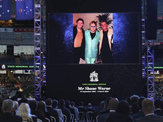 A photo of Elton John and Shane Warne is projected onto a screen during a memorial service for Warne at the Melbourne Cricket Ground in Melbourne. AP Photo/Asanka Brendon Ratnayake)