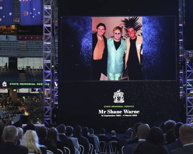 A photo of Elton John and Shane Warne is projected onto a screen during a memorial service for Warne at the Melbourne Cricket Ground in Melbourne. AP Photo/Asanka Brendon Ratnayake)