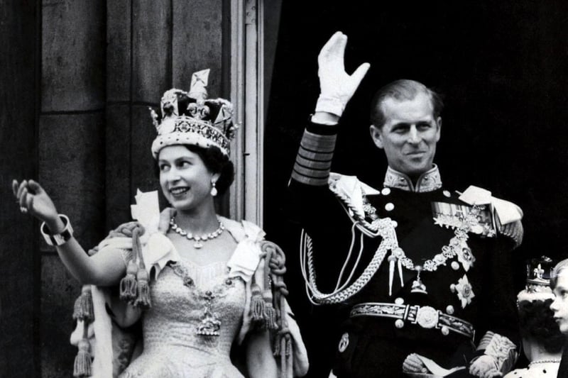 June 2, 1953 - Queen Elizabeth II wearing the Imperial State Crown, and the Duke of Edinburgh in the uniform of the Admiral of the Fleet, wave from the balcony to the onlooking crowds around the gates of Buckingham Palace after the Queen's Coronation Picture: PA Wire