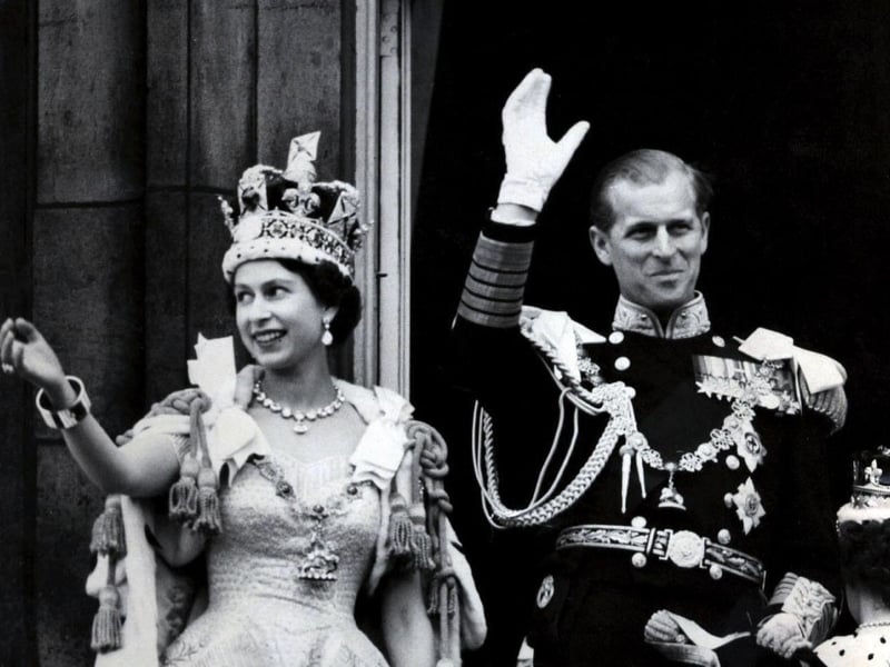 June 2, 1953 - Queen Elizabeth II wearing the Imperial State Crown, and the Duke of Edinburgh in the uniform of the Admiral of the Fleet, wave from the balcony to the onlooking crowds around the gates of Buckingham Palace after the Queen's Coronation Picture: PA Wire