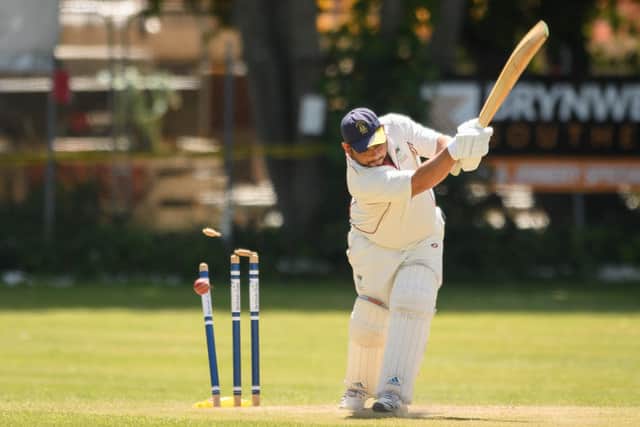 US Portsmouth opener Sesh Nadathur is bowled by Portsmouth & Southsea's Mo Ali. Picture: Keith Woodland