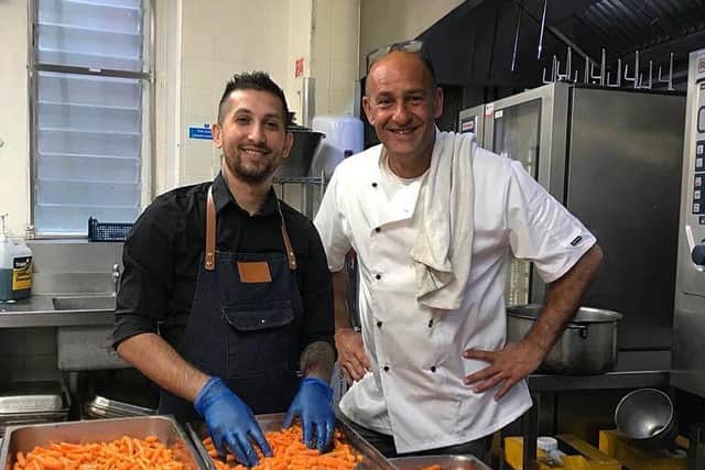 Anghel Niko Nedelcu and Farid Yeganeh preparing meals before they were delivered across Portsmouth.