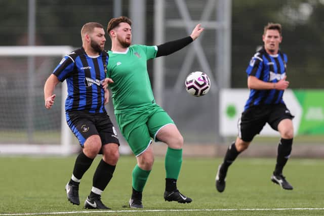 Cowplain (green) v Mob Albion in the Mid-Solent League last October - the two clubs will be top of their respective divisions when the season restarts next month. Picture: Chris Moorhouse