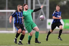 Cowplain (green) v Mob Albion in the Mid-Solent League last October - the two clubs will be top of their respective divisions when the season restarts next month. Picture: Chris Moorhouse