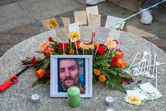 Tributes to Wayne Elliott present during the vigil in Commercial Road. Picture: Mike Cooter