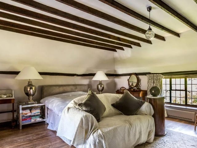 The listing says: "Enjoying established secluded gardens, a delightful Grade II listed country cottage featuring a host of period features and offering adaptable accommodation that includes an annexe."