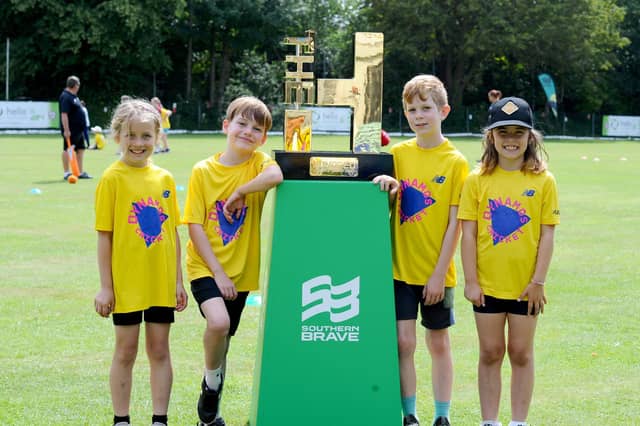 Children from schools across Portsmouth gathered at Portsmouth & Southsea CC for a free skills day organised by the Hampshire Cricket Board. From left - Autumn (8), Hector (10), Sam (8) and Nia (7) with The Hundred trophy. Picture: Sarah Standing
