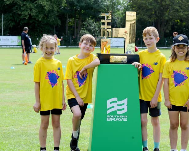 Children from schools across Portsmouth gathered at Portsmouth & Southsea CC for a free skills day organised by the Hampshire Cricket Board. From left - Autumn (8), Hector (10), Sam (8) and Nia (7) with The Hundred trophy. Picture: Sarah Standing