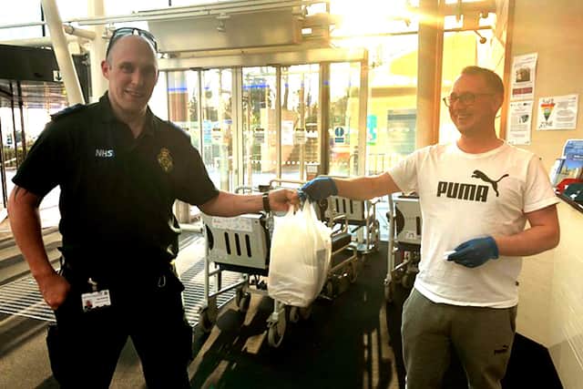 Former patient Aaron Willis (right) from Wok Express delivers free takeaway to a SCAS paramedic