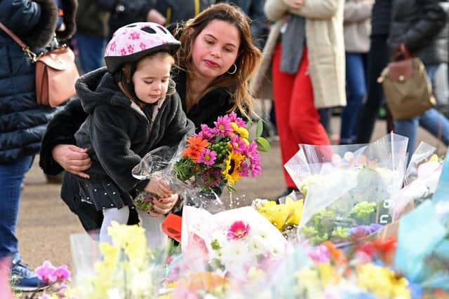 Well-wishers lay flowers to honour murder victim Sarah Everard at the bandstand on Clapham Common in south London on March 14, 2021, a day after Metropolitan Police officers scuffled at the spot with some members of a hundreds-strong crowd that gathered for a candlelit tribute. 
Photo by DANIEL LEAL-OLIVAS/AFP via Getty Images