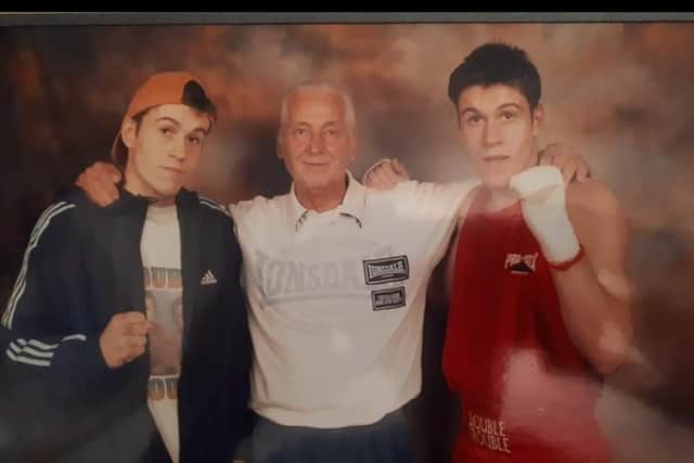 Twin brothers Ashley, left, and Joshua Leigh, right, with former coach Teddy Harris