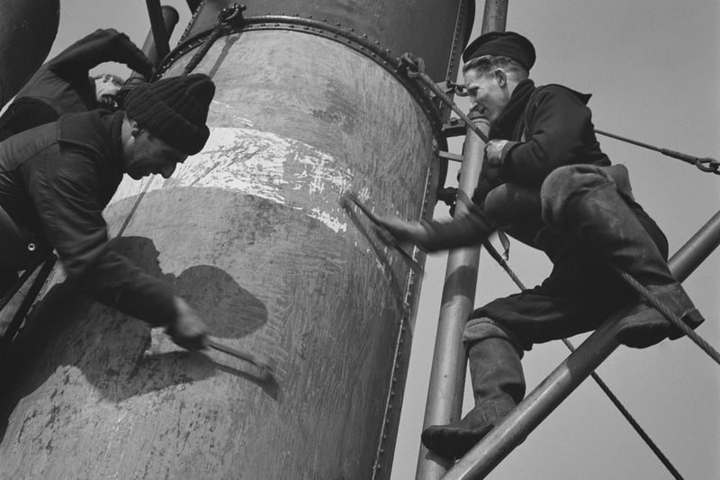 Crew members working on the funnel of a Royal Navy minesweeper during World War II, March 1941.  (Photo by Horace Abrahams/Keystone Features/Hulton Archive/Getty Images)