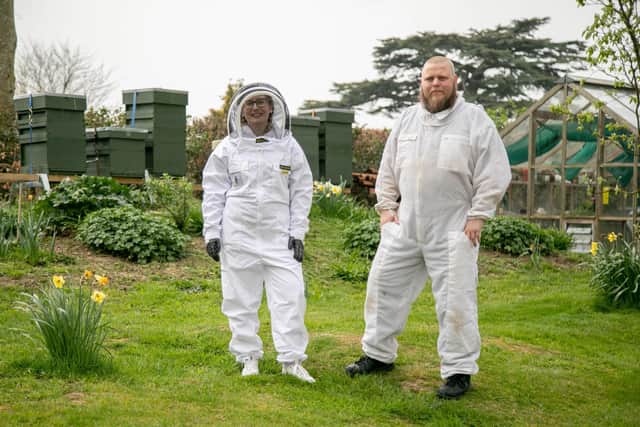 Weekend Cover story on what its like to be a bee keeper

Pictured: News reporter Hollie Busby and Aaron Dancey of Portsmouth Beekeeping Association in bee keeping attire in West Ashling on 29th March 2022

Picture: Habibur Rahman