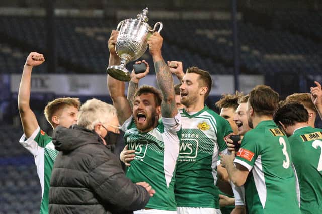 Moneyfields captain Steve Hutchings lift the Portsmouth Senior Cup after a penalty shoot-out win over Baffins at Fratton Park last May.