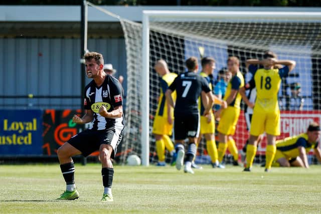 The passion of the FA Cup - a Wimborne player celebrates their equaliser against Moneyfields. Picture by Dave Bodymore.
