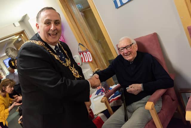 East Cosham House Care Home's registered manager David Fuller, a former lord mayor, with a Portsmouth care home resident in March. Picture: Duncan Shepherd
