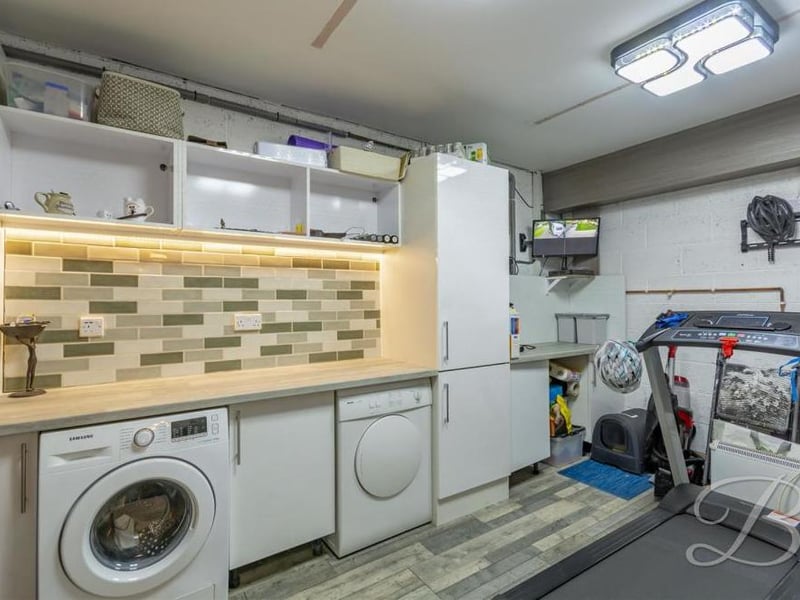 This busy utility room has cupboards for additional storage, a work surface and plumbing for a washing machine and dishwasher. It could even double up as a mini-gym, if required.