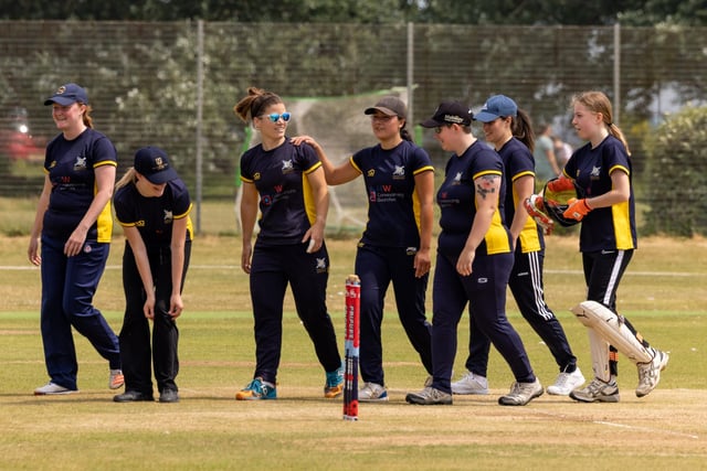 A pat on the back for Portsmouth bowler Lauren Urch. Picture: Mike Cooter