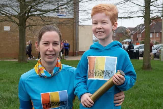 Vicki (left) and Owen Brunink with the golden baton being passed around parkruns across the country. Picture: Keith Woodland (22022020-7)