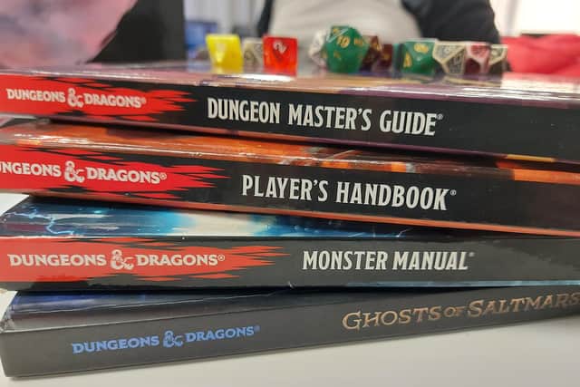 Dungeons and Dragons manuals with a selection of dice used in the role-playing game