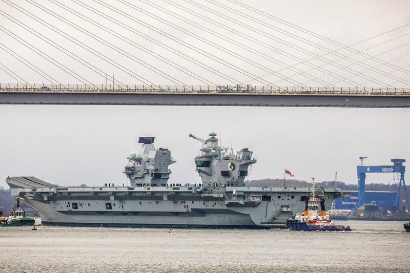 HMS Queen Elizabeth makes her way under the Forth Bridges as she prepares to dock at Rosyth dockyard for repairs, March 21 2024.