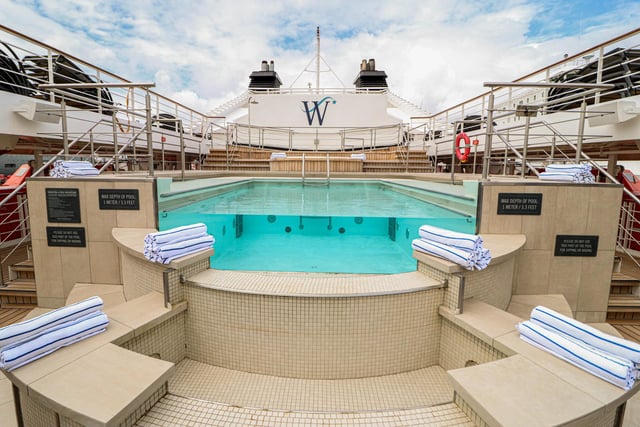 Explore the inside of Star Legend, a luxurious cruise ship operated by Windstar Cruises. Pictured is the outdoor swimming pool.